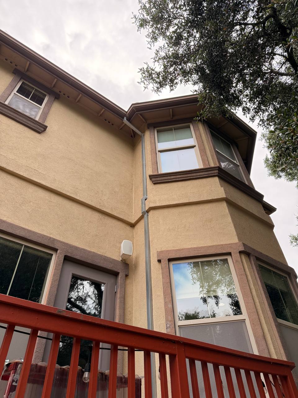 Downspout corner detail stucco bay window Skyline install