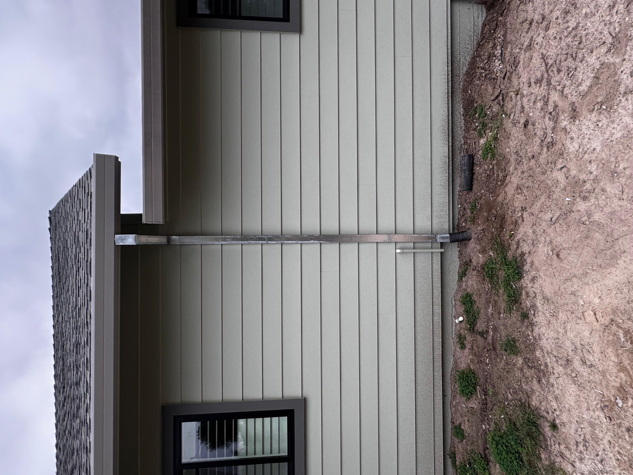 Dead-level seamless gutter horizontal run with dual downspouts